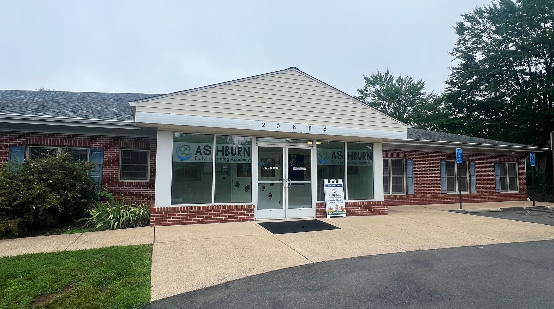 The brick entrance of Ashburn Early Learning Academy at 20854 Stubble Road, surrounded by trees and greenery